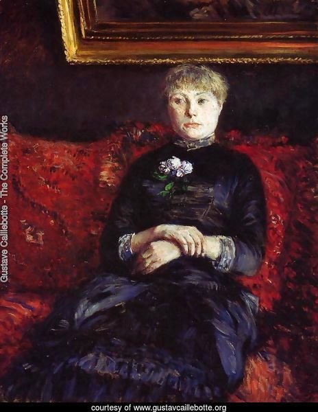 Woman Sitting on a Red-Flowered Sofa